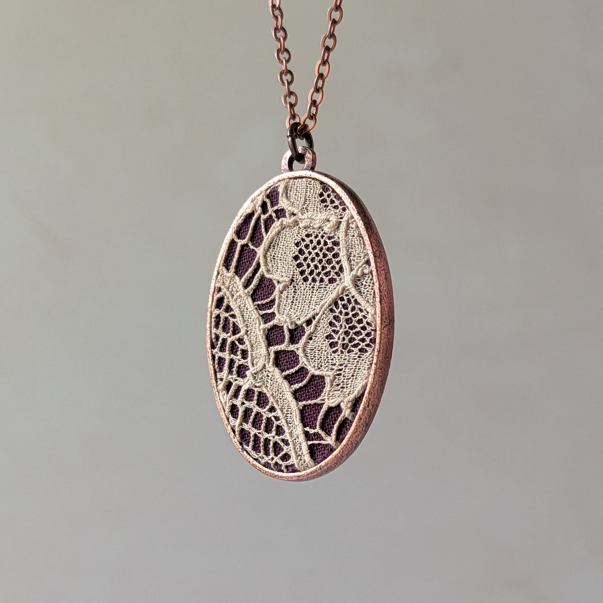 Copper Oval Pendant With 1920s French Lace On Burgundy Cotton