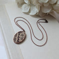 Load image into Gallery viewer, Copper Oval Pendant With 1920s French Lace On Burgundy Cotton
