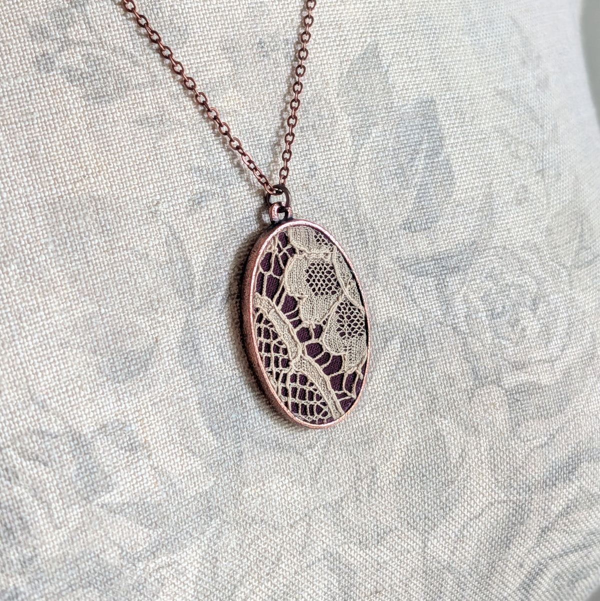 Copper Oval Pendant With 1920s French Lace On Burgundy Cotton
