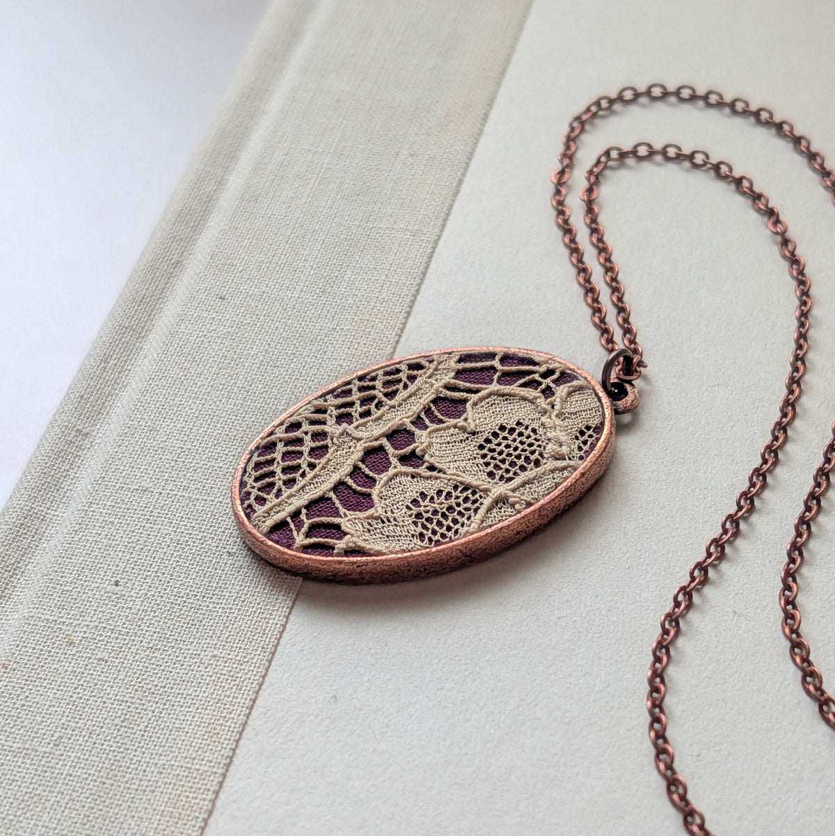 Copper Oval Pendant With 1920s French Lace On Burgundy Cotton