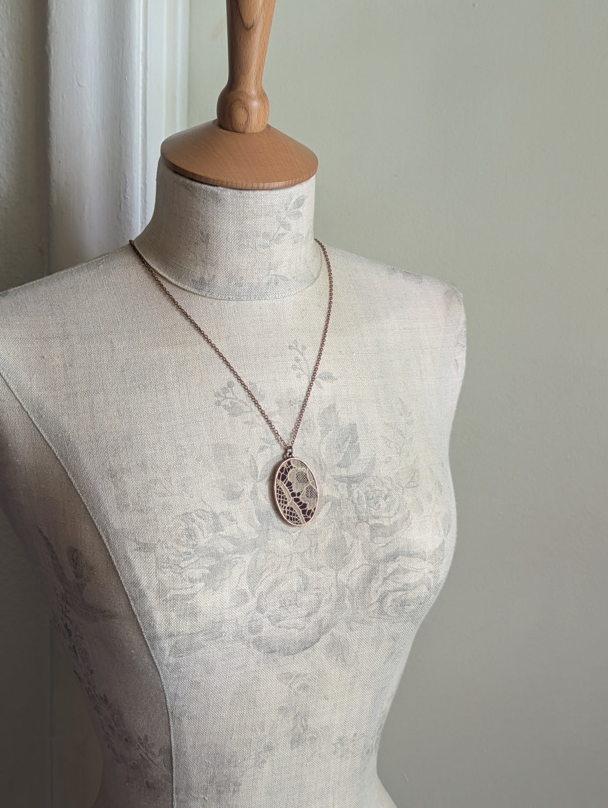 Copper Oval Pendant With 1920s French Lace On Burgundy Cotton
