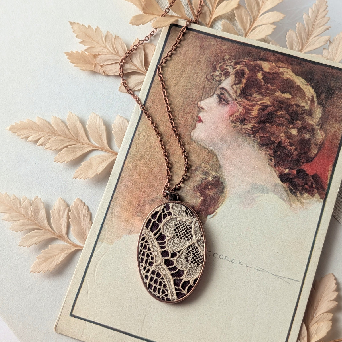 Copper Oval Pendant With 1920s French Lace On Burgundy Cotton