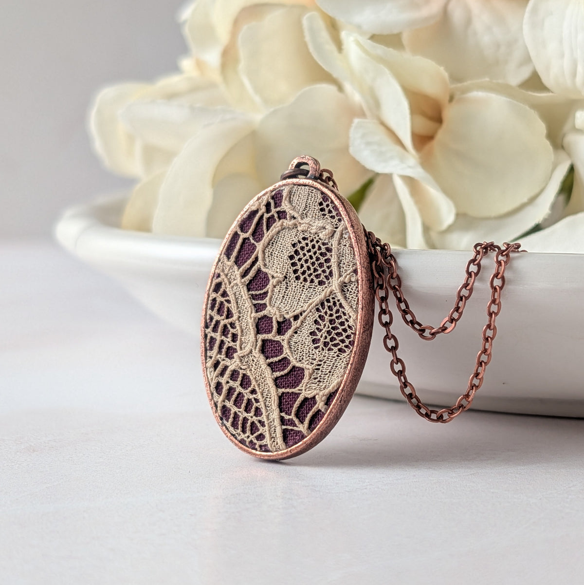 Copper Oval Pendant With 1920s French Lace On Burgundy Cotton