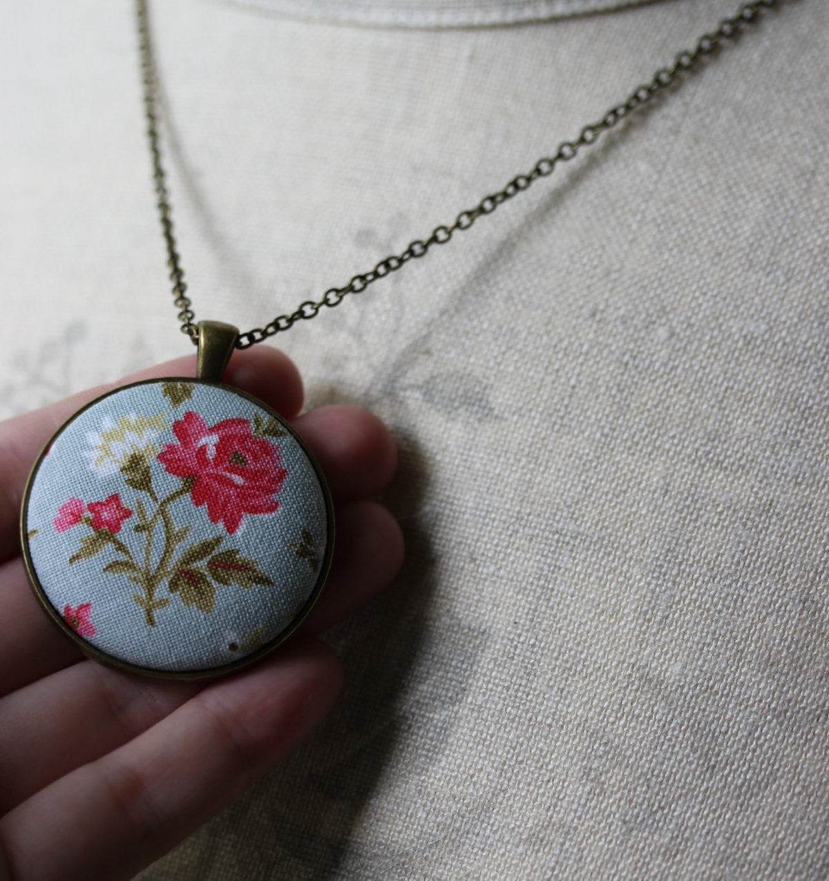 Pink Rose Necklace With Pastel Blue Background
