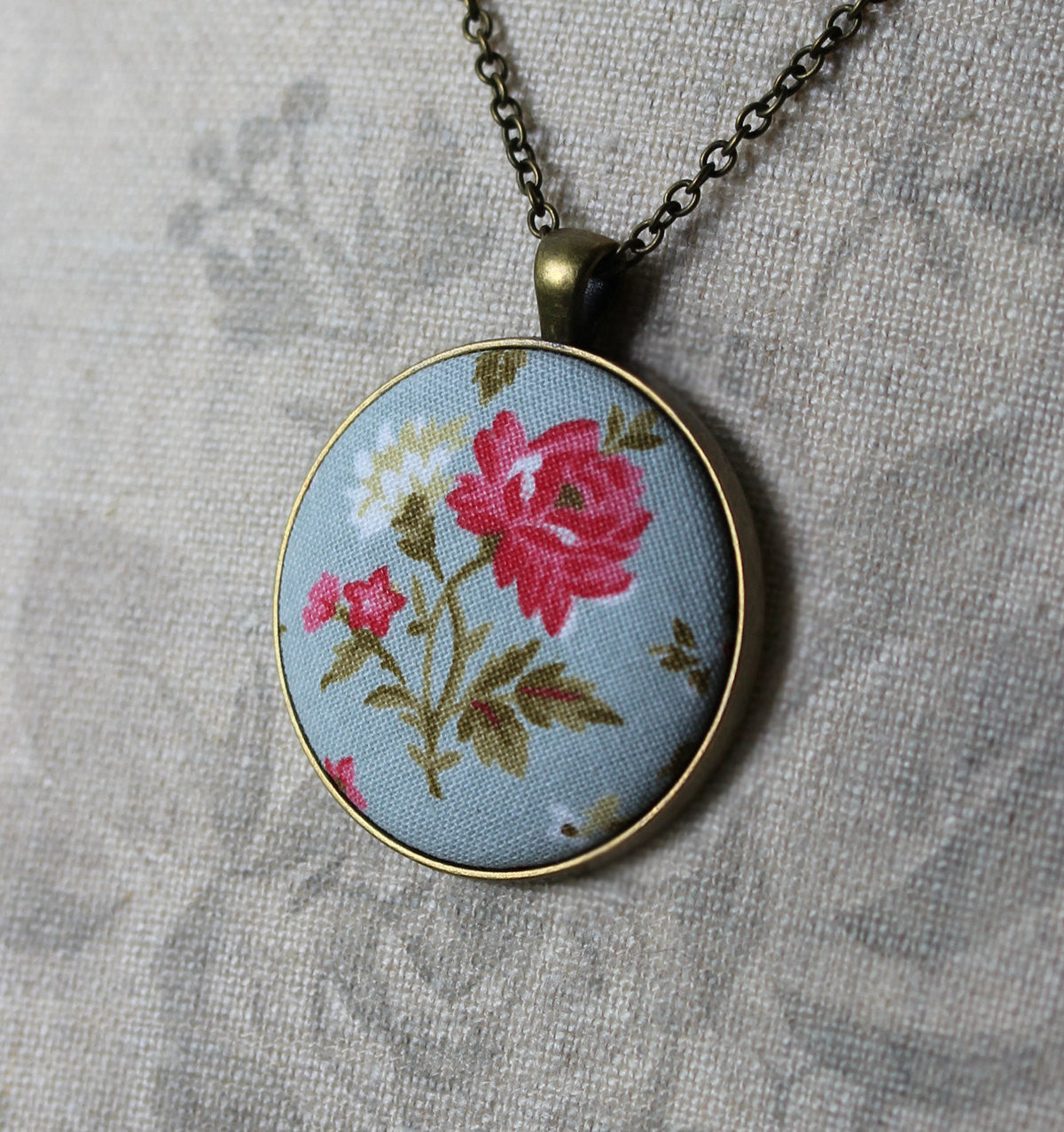 Pink Rose Necklace With Pastel Blue Background